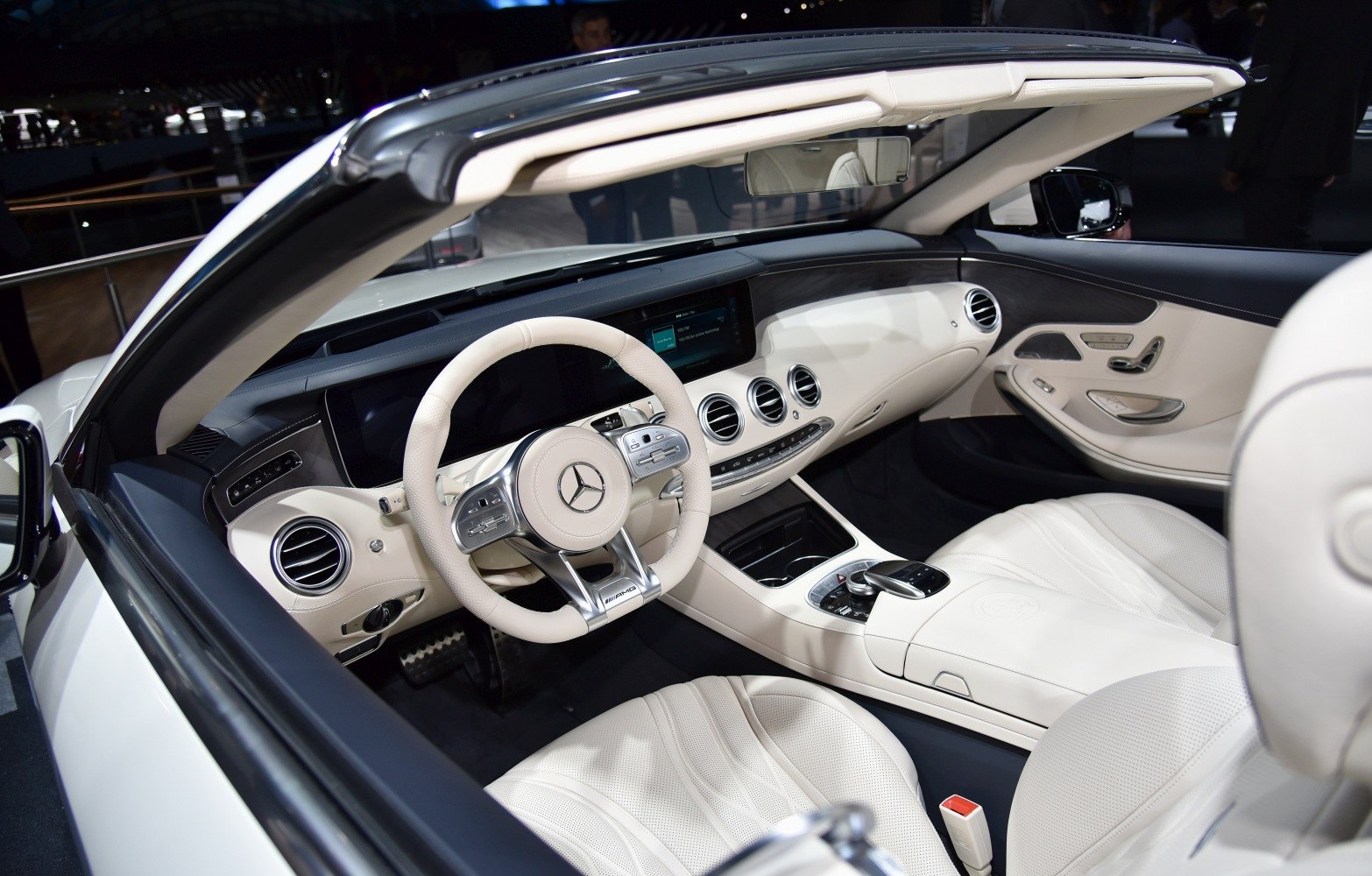 Luxury convertible interior with advanced dashboard and cream leather seats