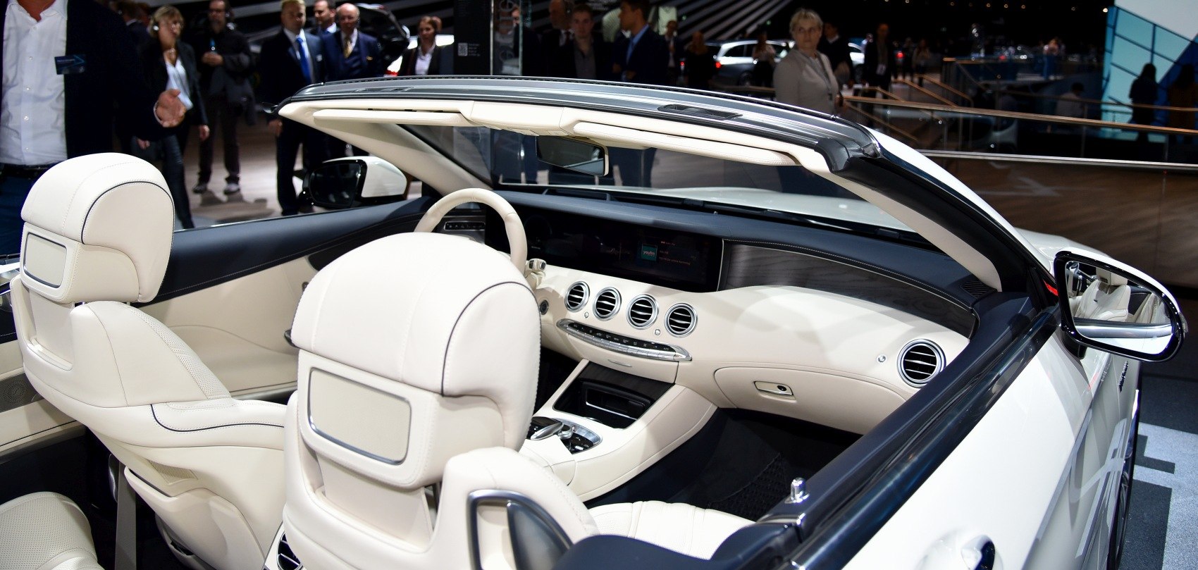 White leather luxury convertible interior with advanced dashboard and 4 circular air vents