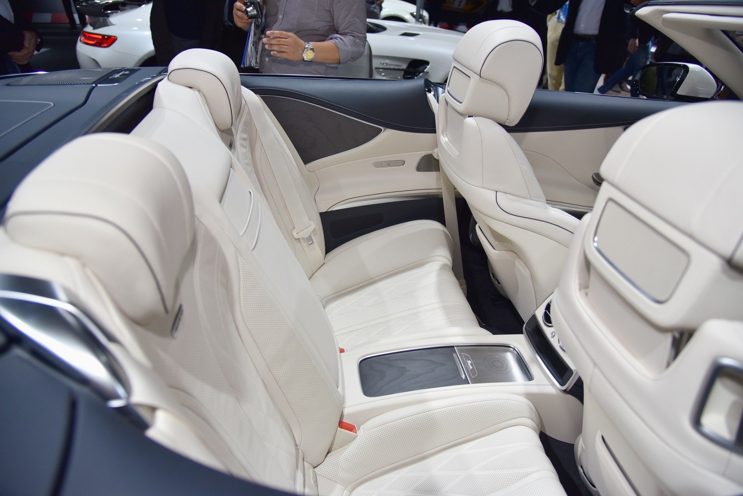 Luxurious light beige leather rear seats with wooden trim