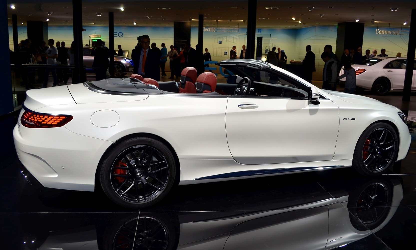Luxury white cabriolet with black alloy wheels and red seats