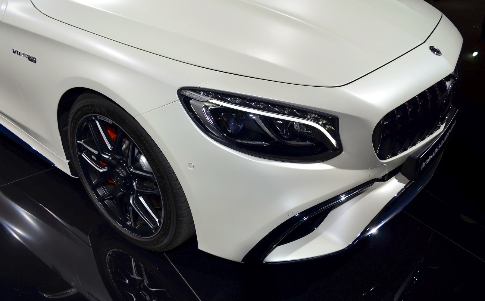 Front headlight and black alloy wheel with red brake caliper