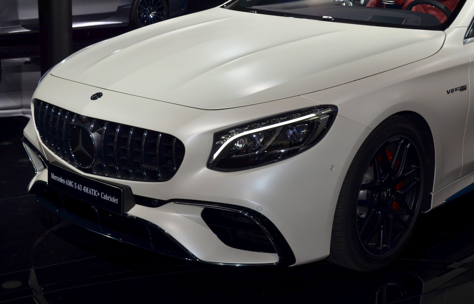 Close-up of front grille and LED headlight with V8 biturbo badge