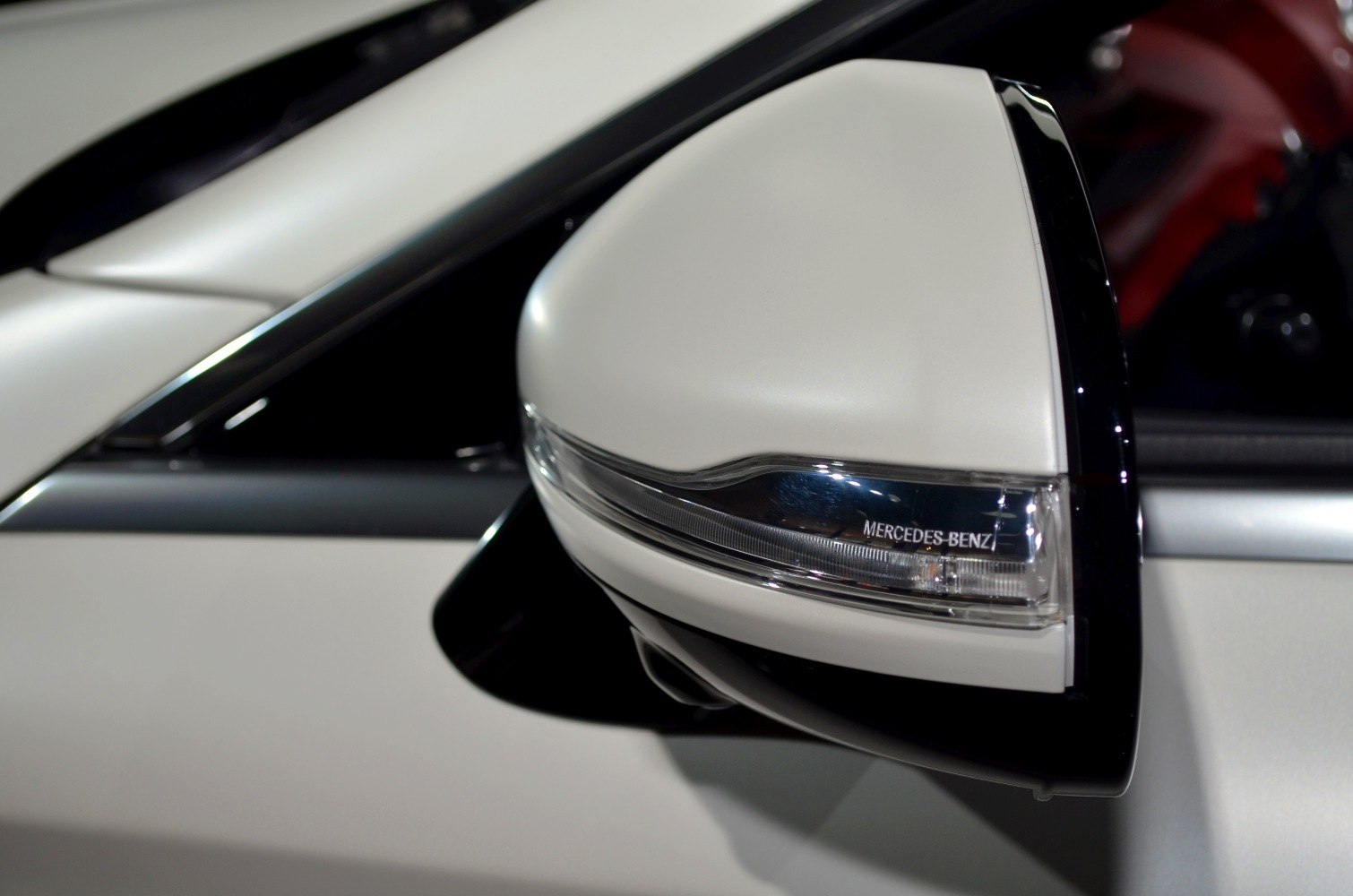 Close-up of side mirror with integrated turn signal and LED strip
