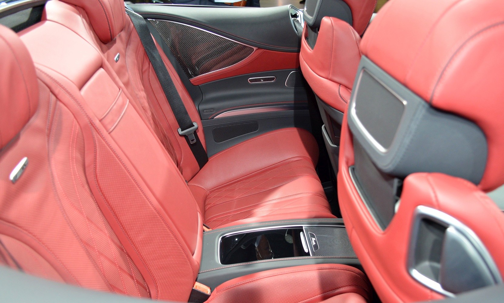 Red leather rear seats with carbon fiber and premium detailing.