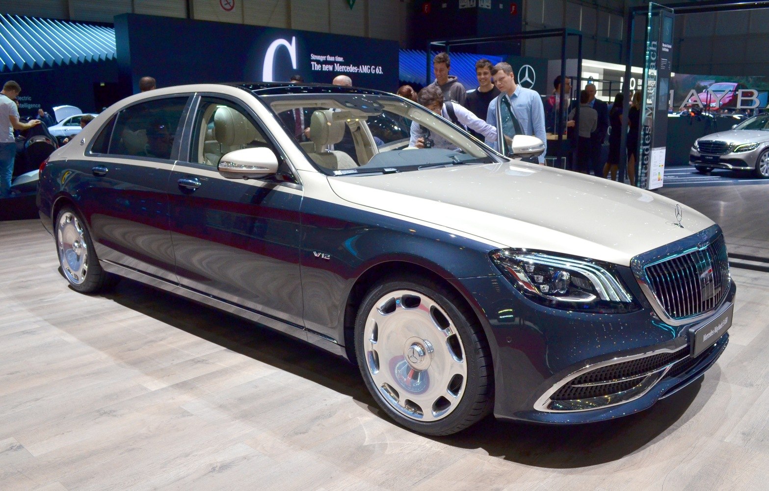 Two-tone luxury sedan with signature grille and V12 badge