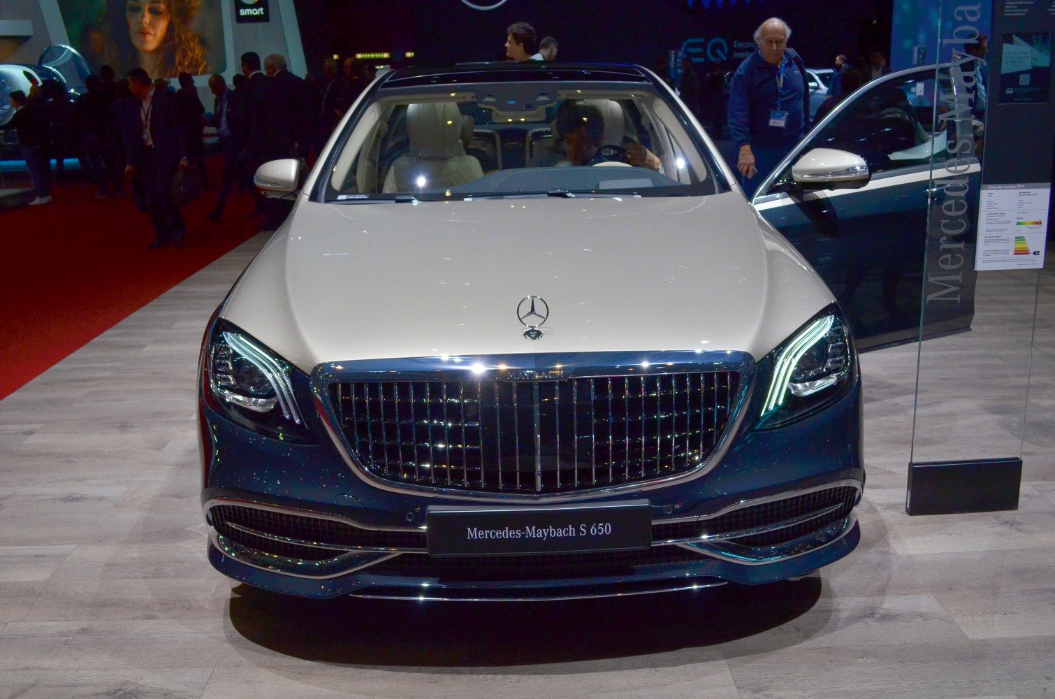 Front view with distinctive grille and illuminated headlights