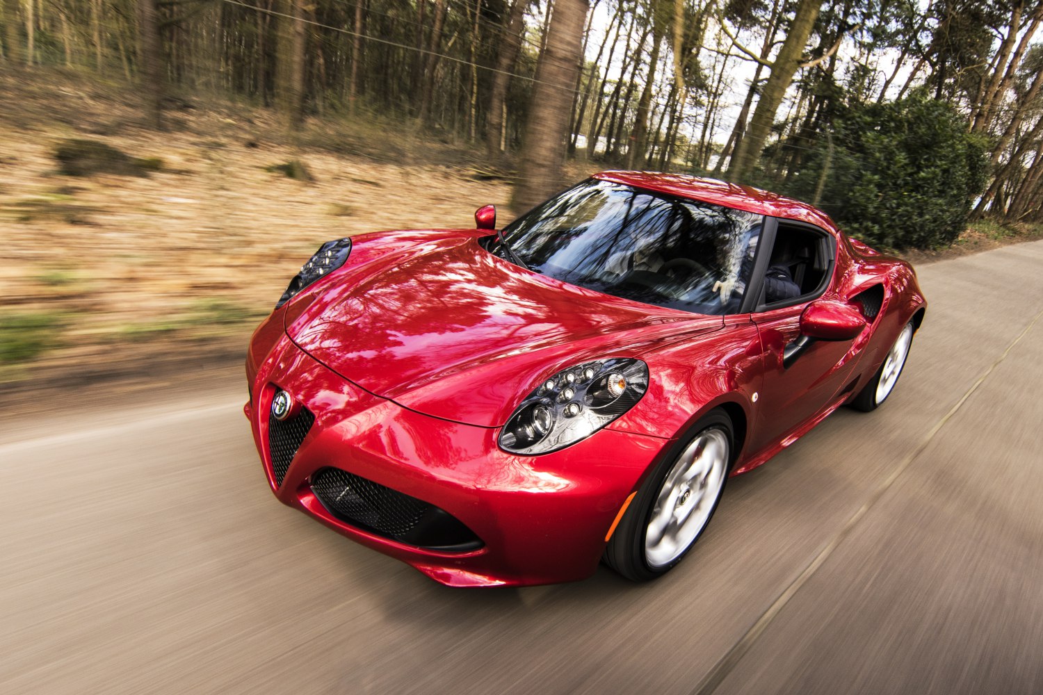 Red sports coupe with rounded headlights and aerodynamic curves