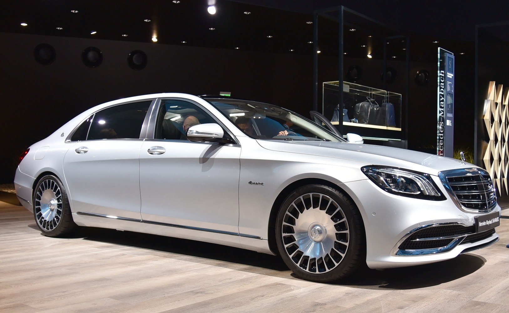 Luxury sedan with distinctive multi-spoke alloy wheels and sleek silver exterior