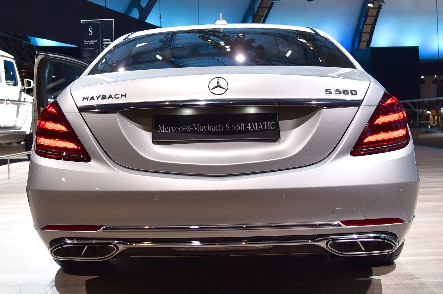 Luxury sedan rear with distinct taillights and dual chrome exhaust