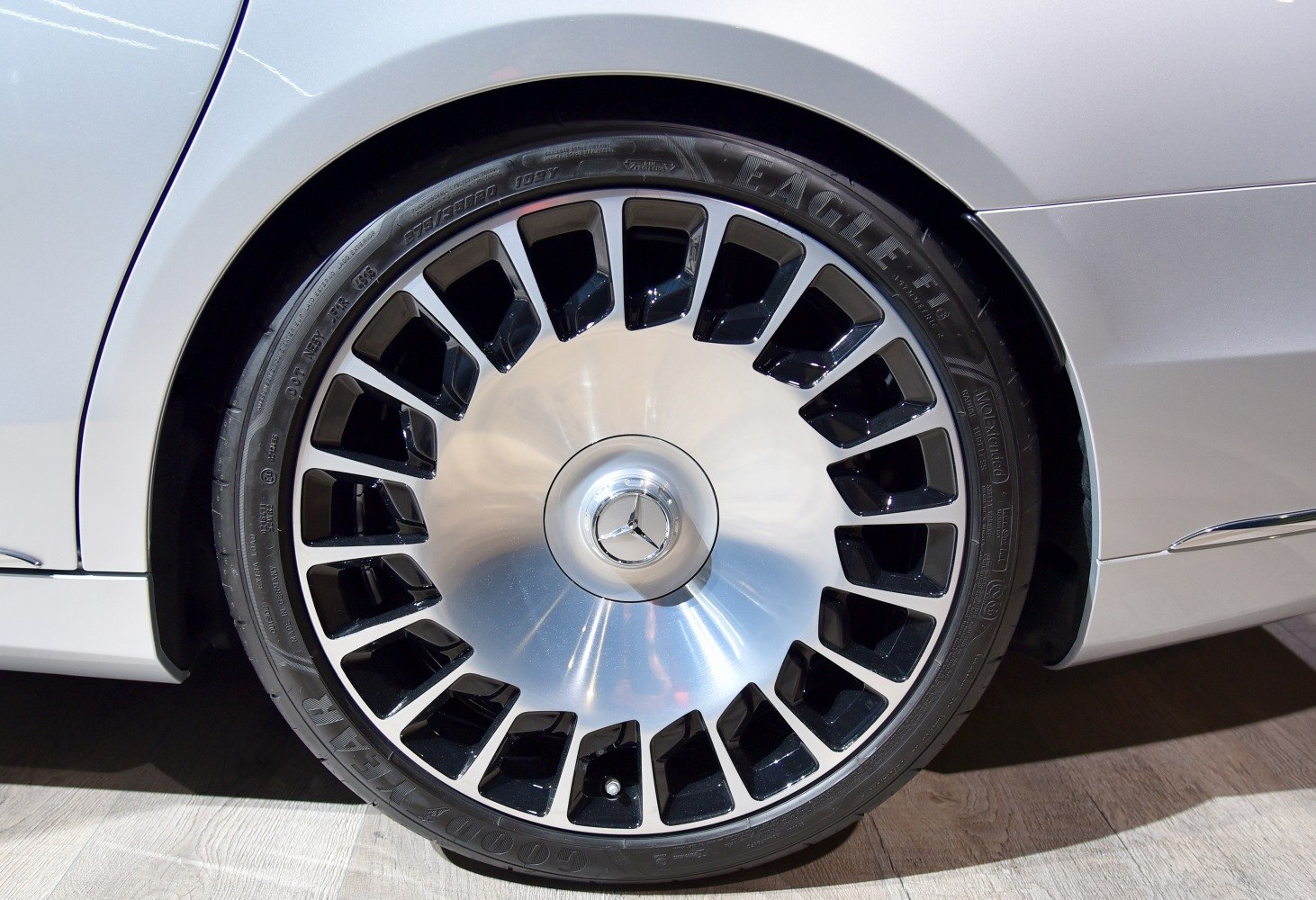 Multi-spoke silver and black alloy wheel with Mercedes logo