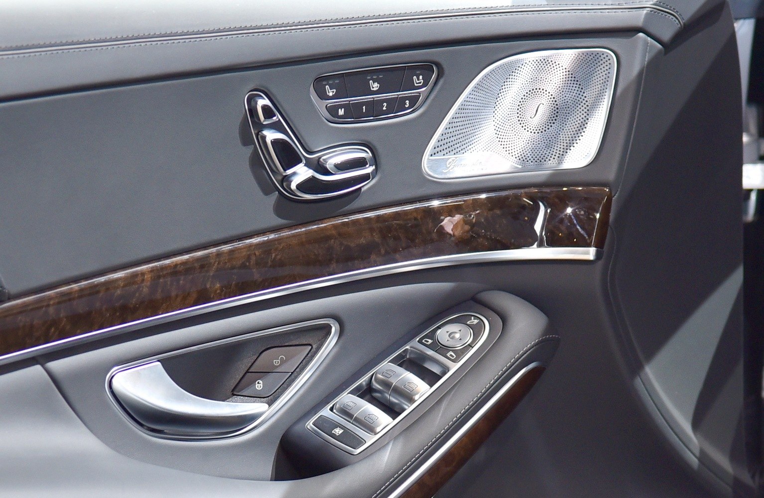 Luxury door panel with seat adjustment and speaker detail