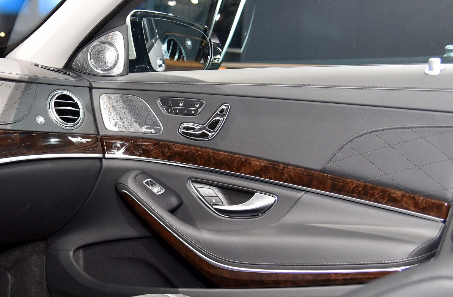 Wooden trim and leather door panel with control buttons