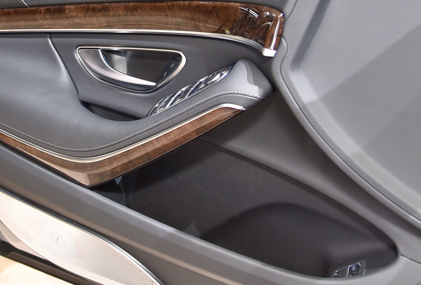 Luxury interior door panel with wood trim and chrome handle