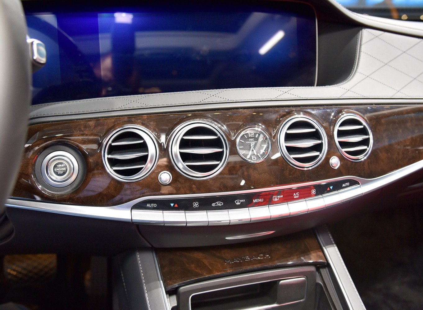 Luxury wood trim dashboard with analog clock and air vents