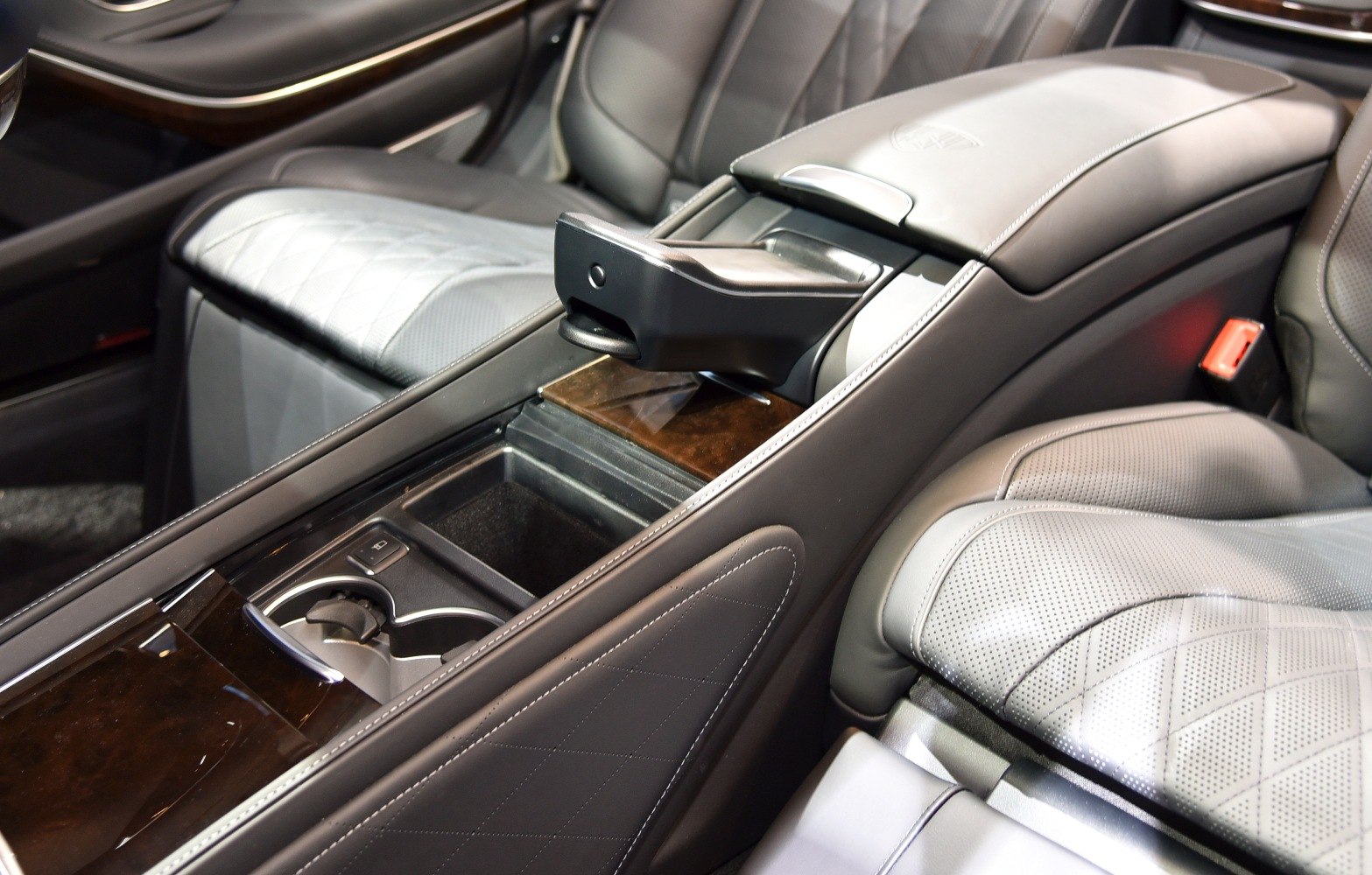 Luxury perforated leather seats and wood-trimmed center console with detailed stitching.