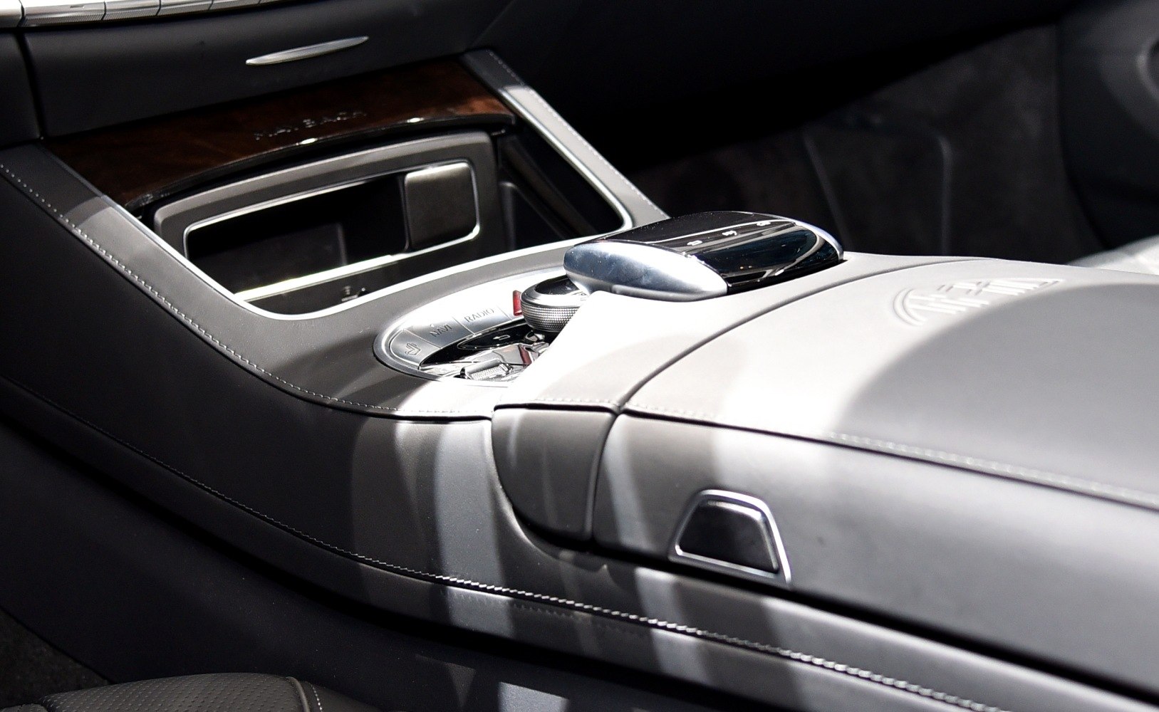 Luxury car center console with wood trim and control dial