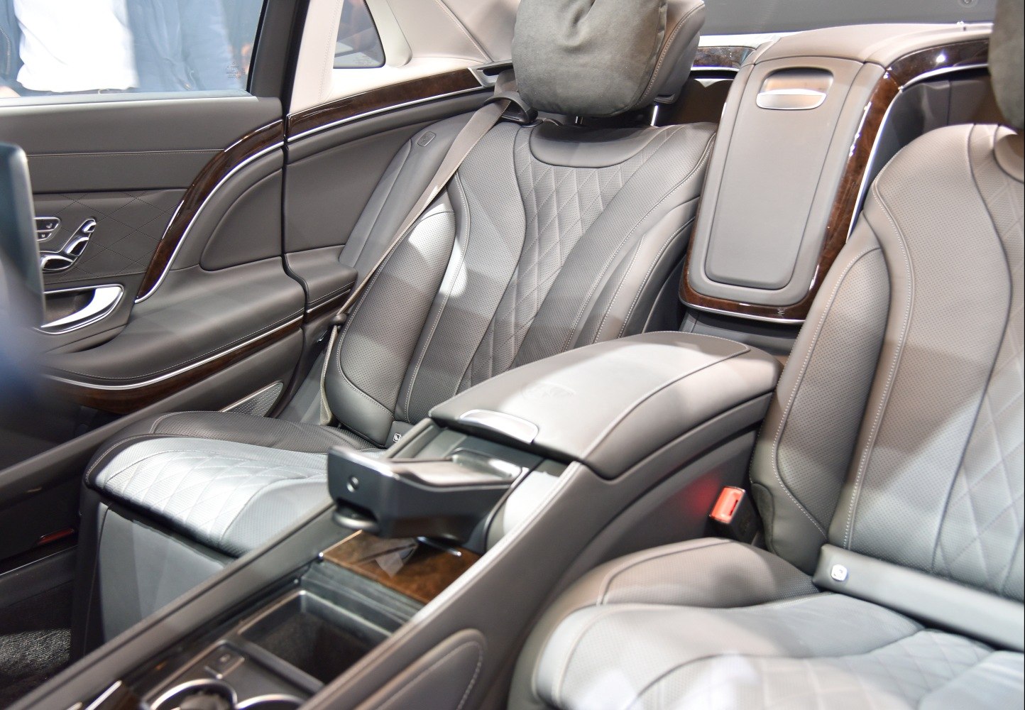 Rear luxury leather seats with diamond pattern stitching and wood trim interior
