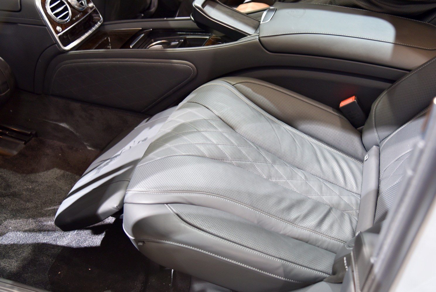 Perforated leather luxury seat with stitching and adjustment controls