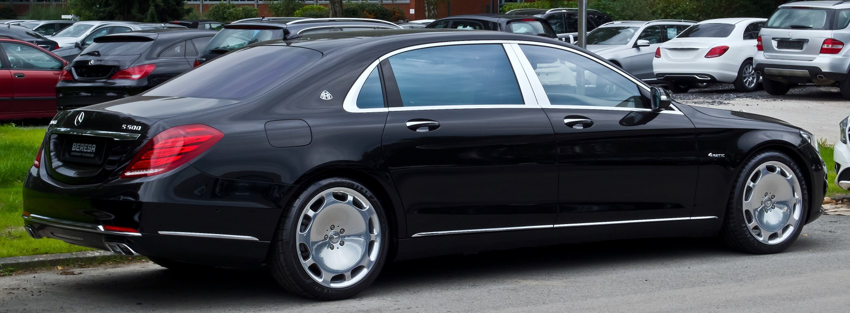 Luxury sedan with chrome trim and covered alloy wheels