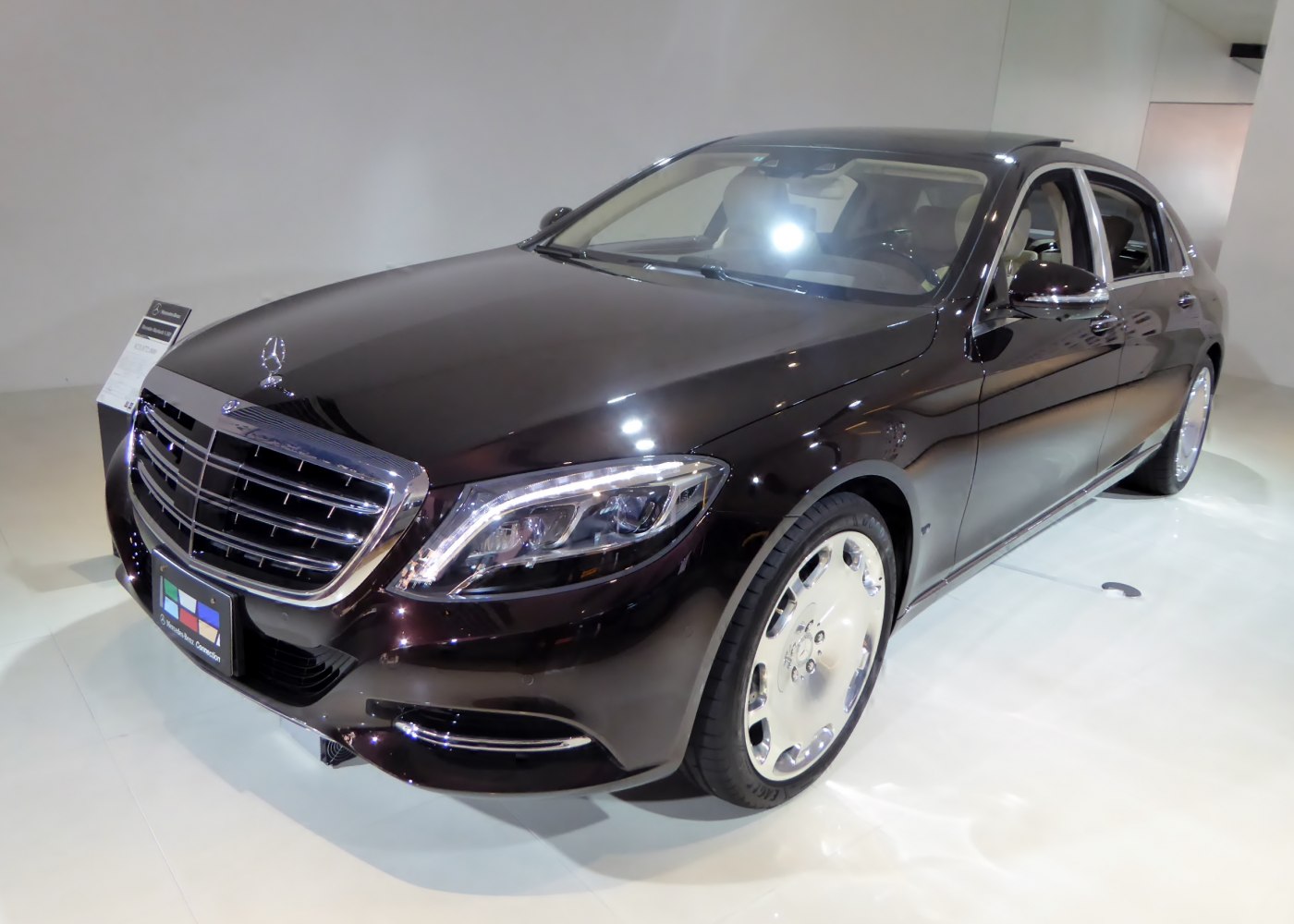 Luxury sedan front grille, headlights, and alloy wheels in elegant design