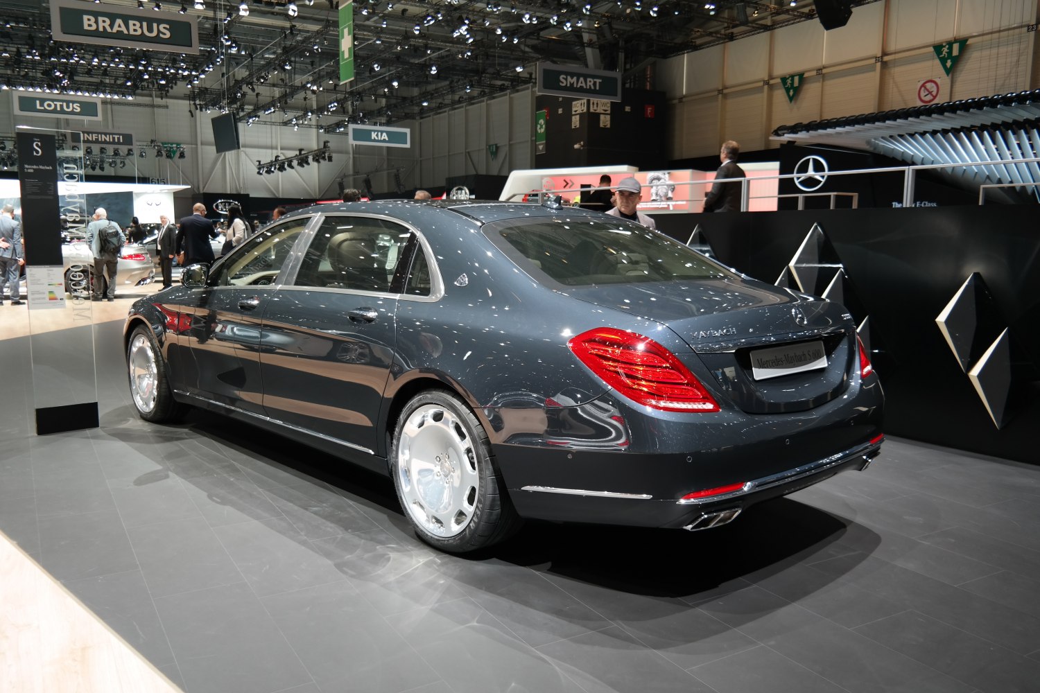 Rear-side view of luxury sedan with chrome wheels and distinctive taillights
