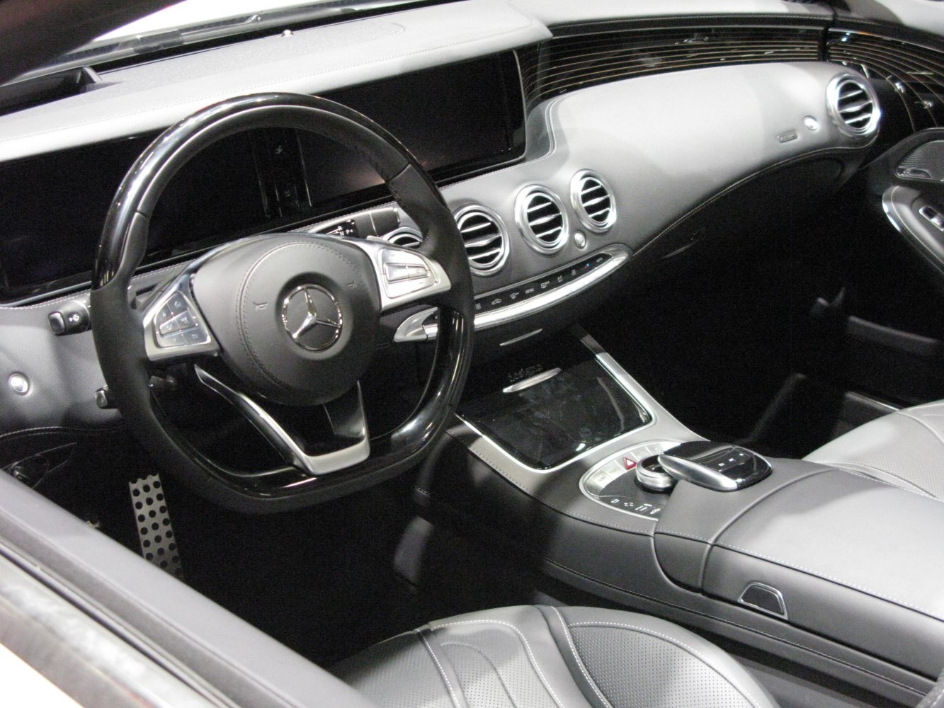 Luxury dashboard and steering wheel with advanced controls and air vents