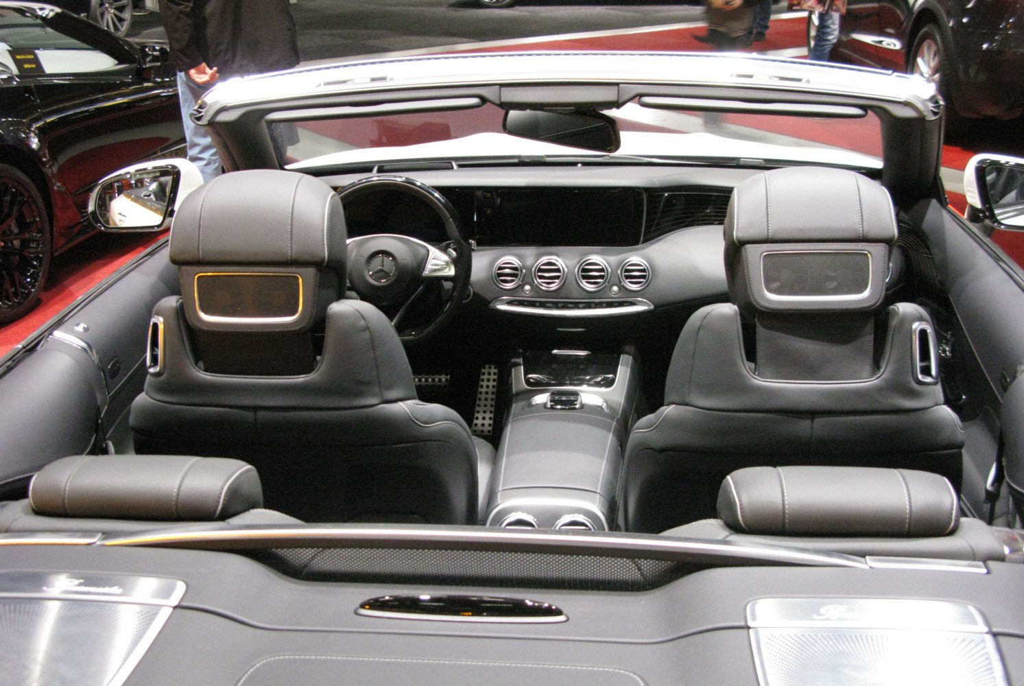 Luxury convertible interior with advanced dashboard and black leather seats