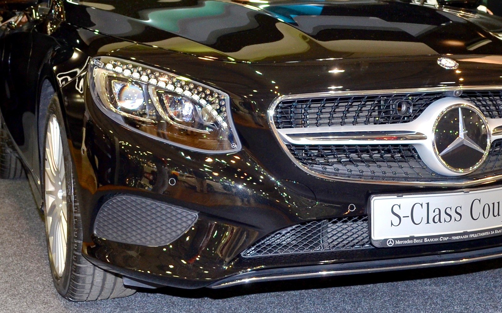 Front LED headlight with grille and emblem