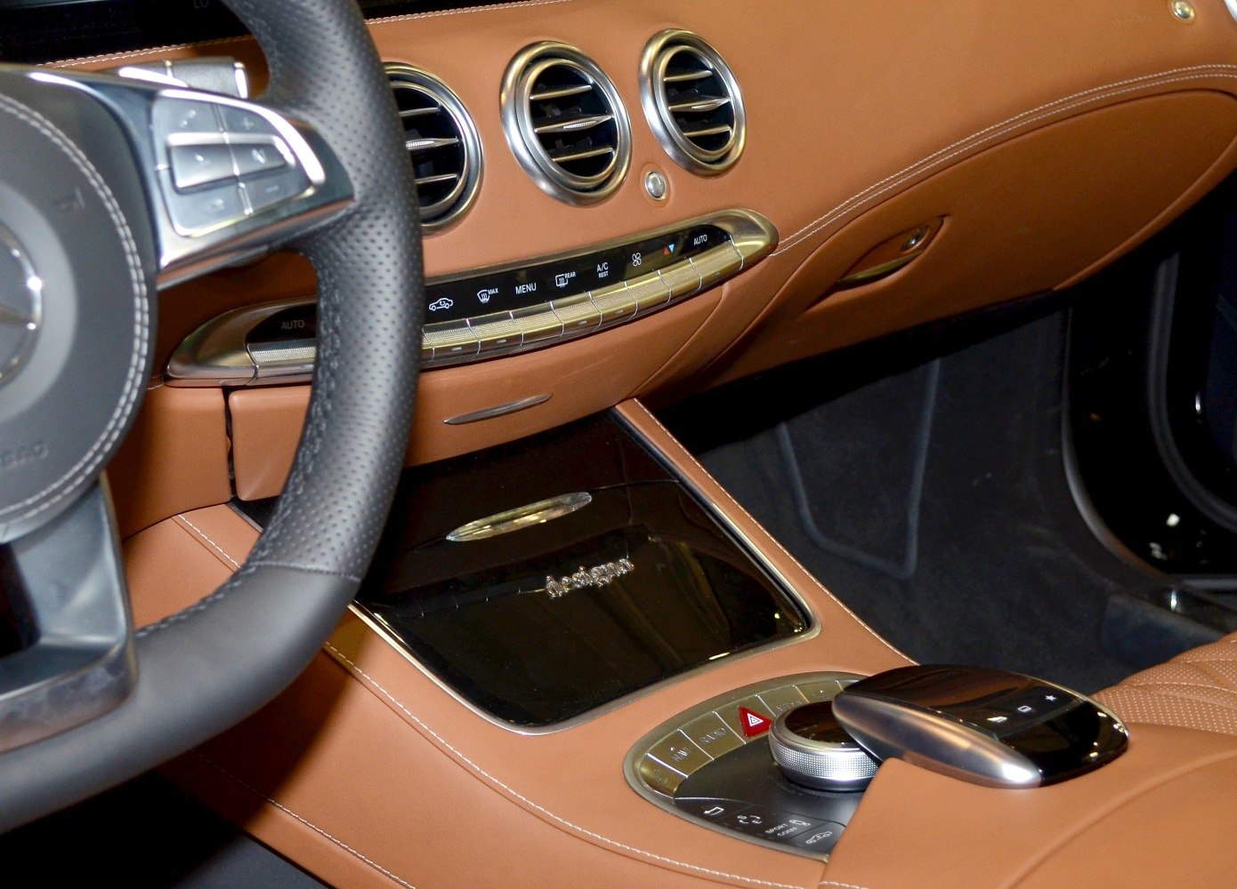 Luxury brown leather interior with advanced center console and climate controls