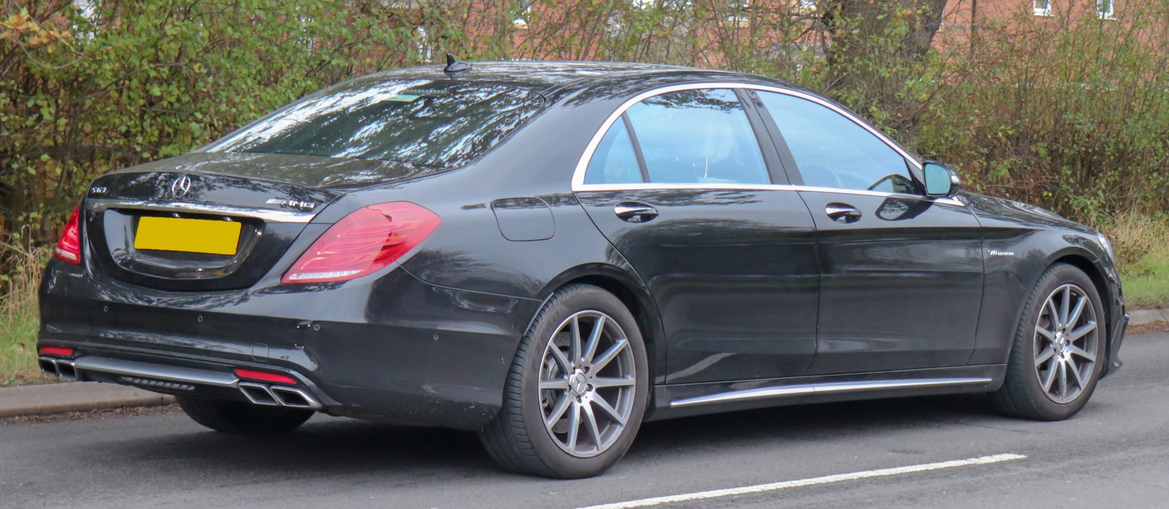 Rear and side view showing AMG wheels and quad exhaust tips