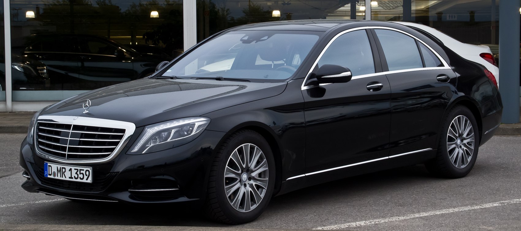Luxury sedan with LED headlights and chrome grille in sleek black finish.
