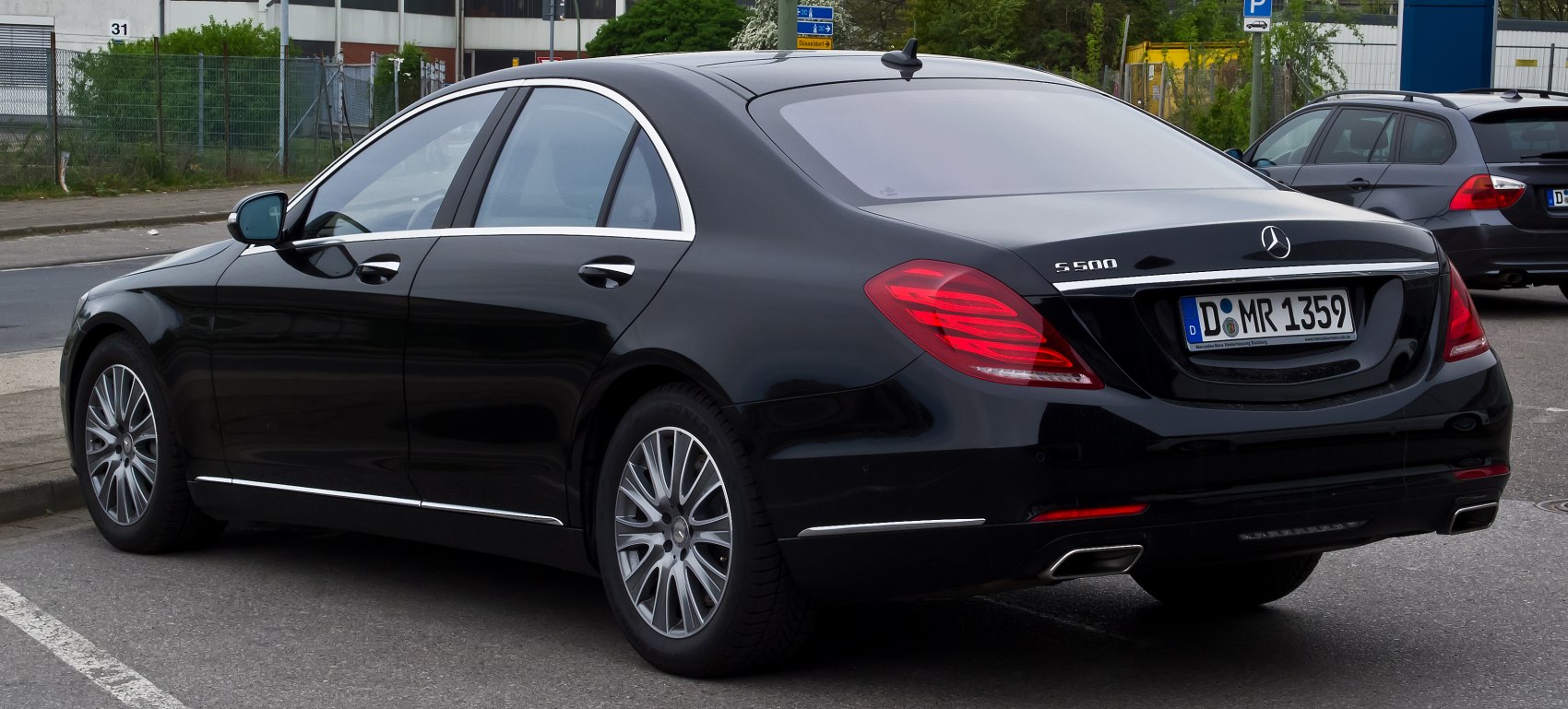 Luxury sedan rear with LED tail lights and dual exhaust tips