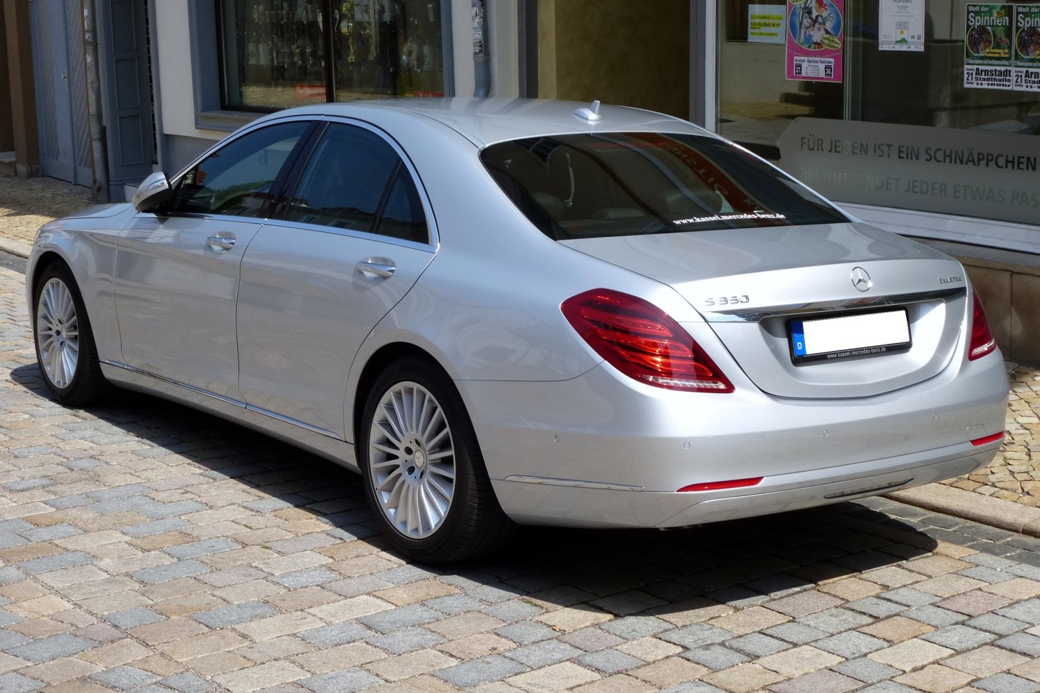 Rear and side view of a luxury sedan with elegant tail lights and alloy wheels