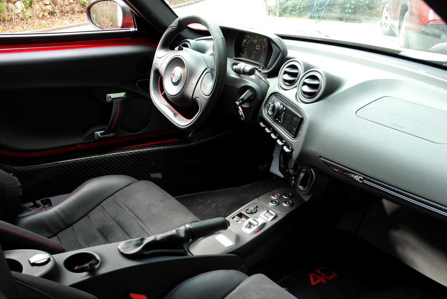 Sport steering wheel, carbon fiber trim, modern dashboard with digital display