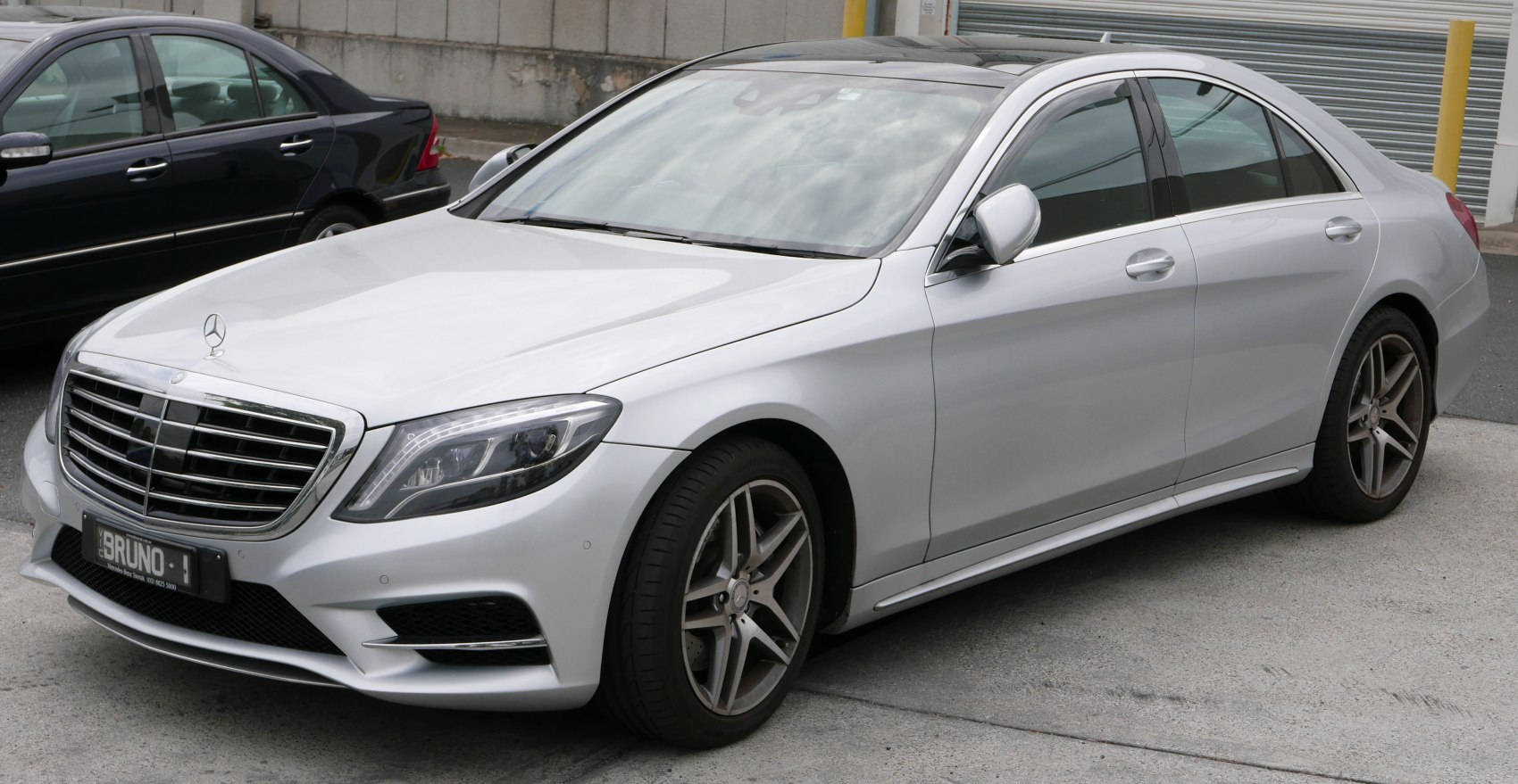 Front-side view of luxury sedan with distinctive grille and alloy wheels