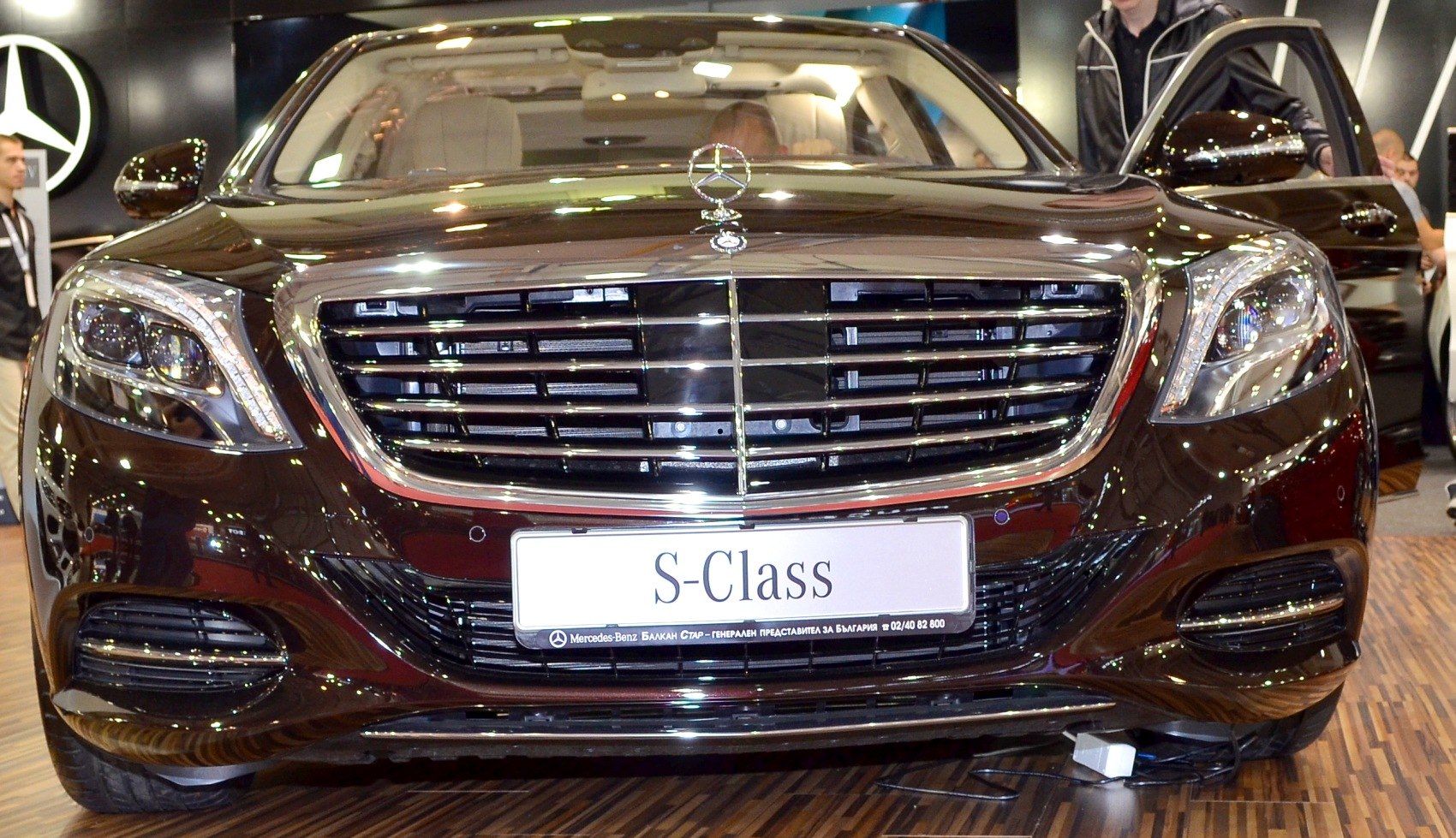 Close view of chrome front grille and LED headlights on a luxury sedan