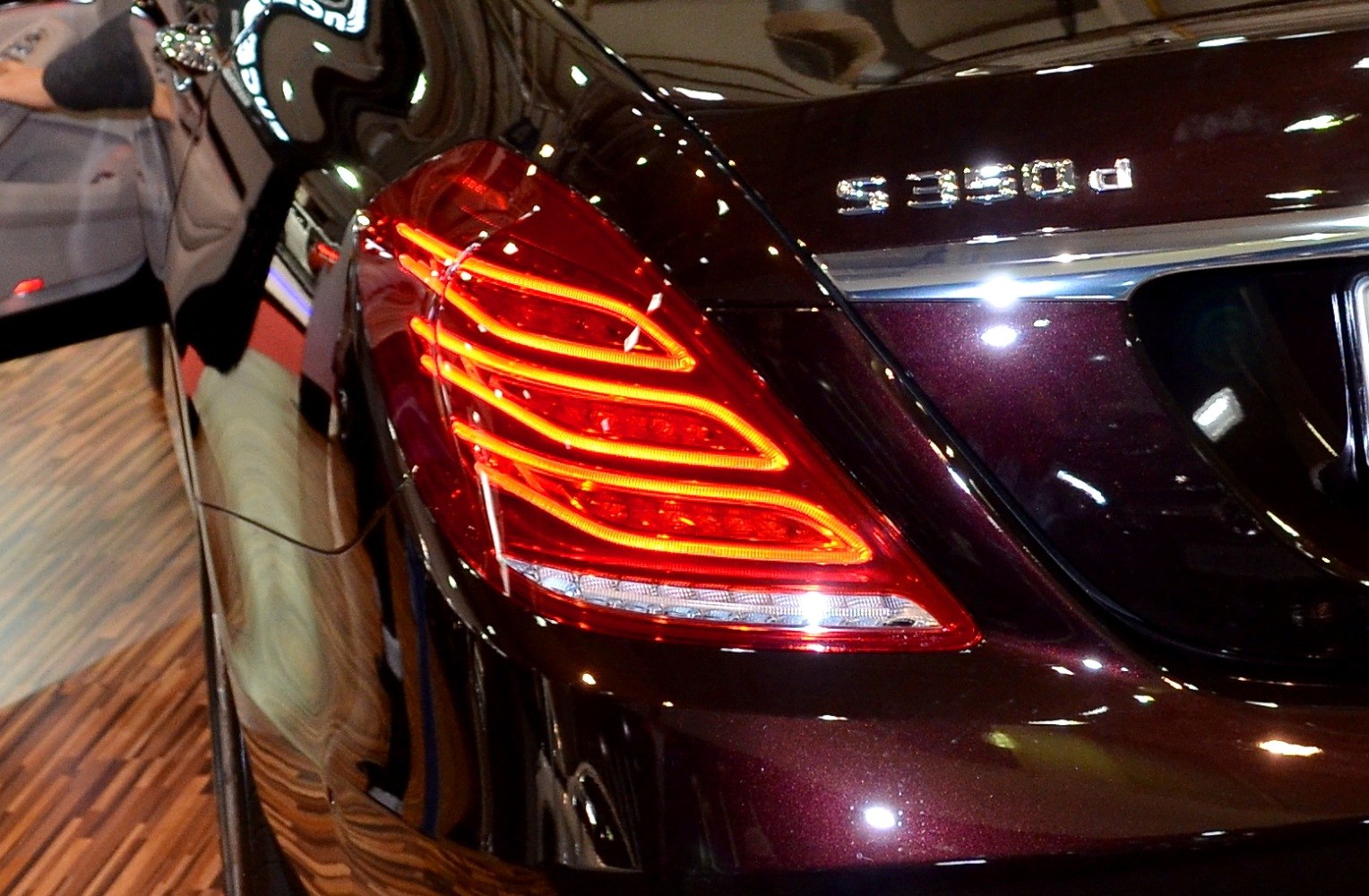 Illuminated LED rear tail light cluster with sleek design and chrome trim.