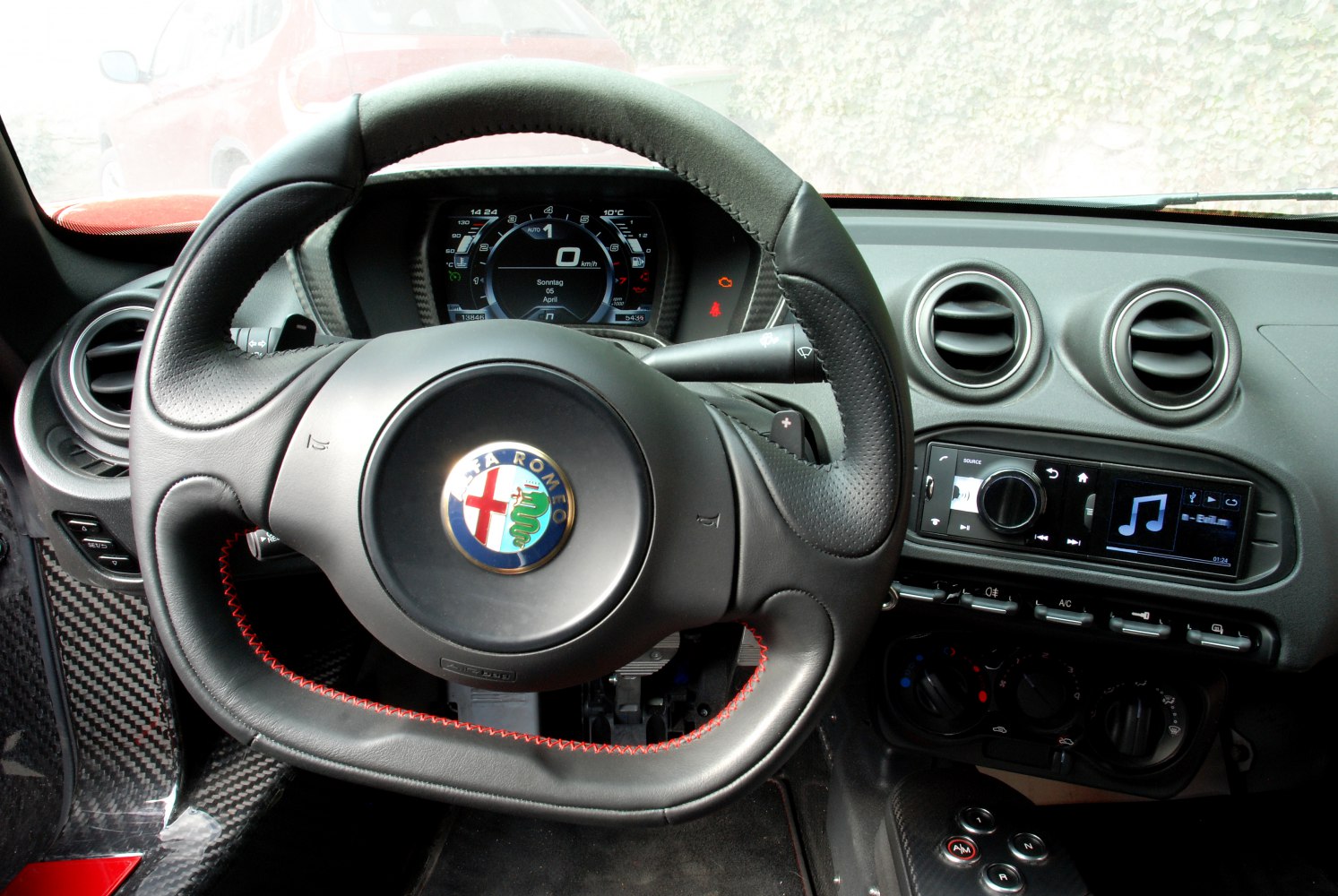 Sporty leather steering wheel with digital instrument cluster and dashboard controls