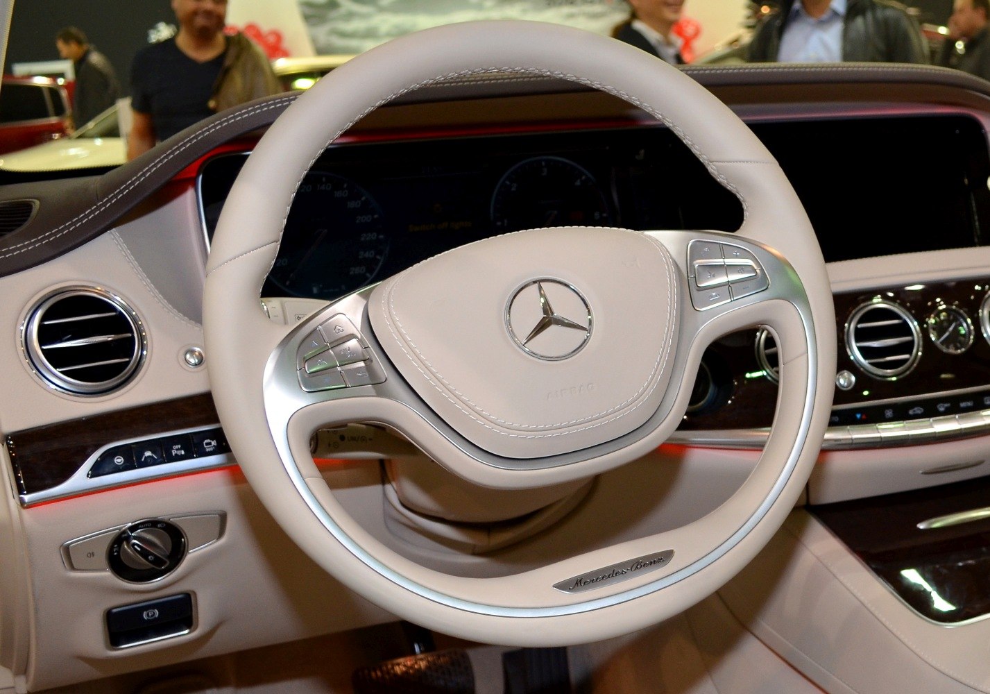 Steering wheel with controls and luxury dashboard with analog clock and air vents