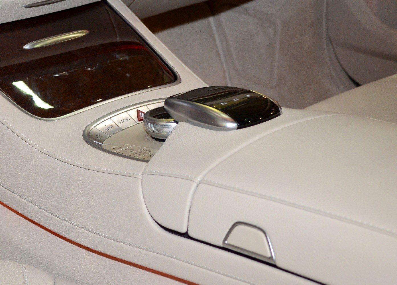 White leather center console with control knob and touchpad