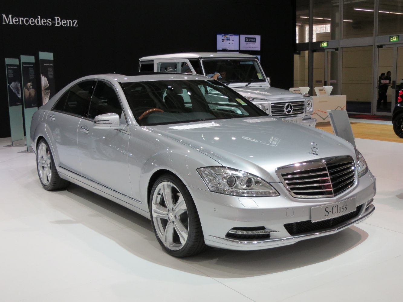 Front and side view of a silver luxury sedan with LED headlights and chrome grille