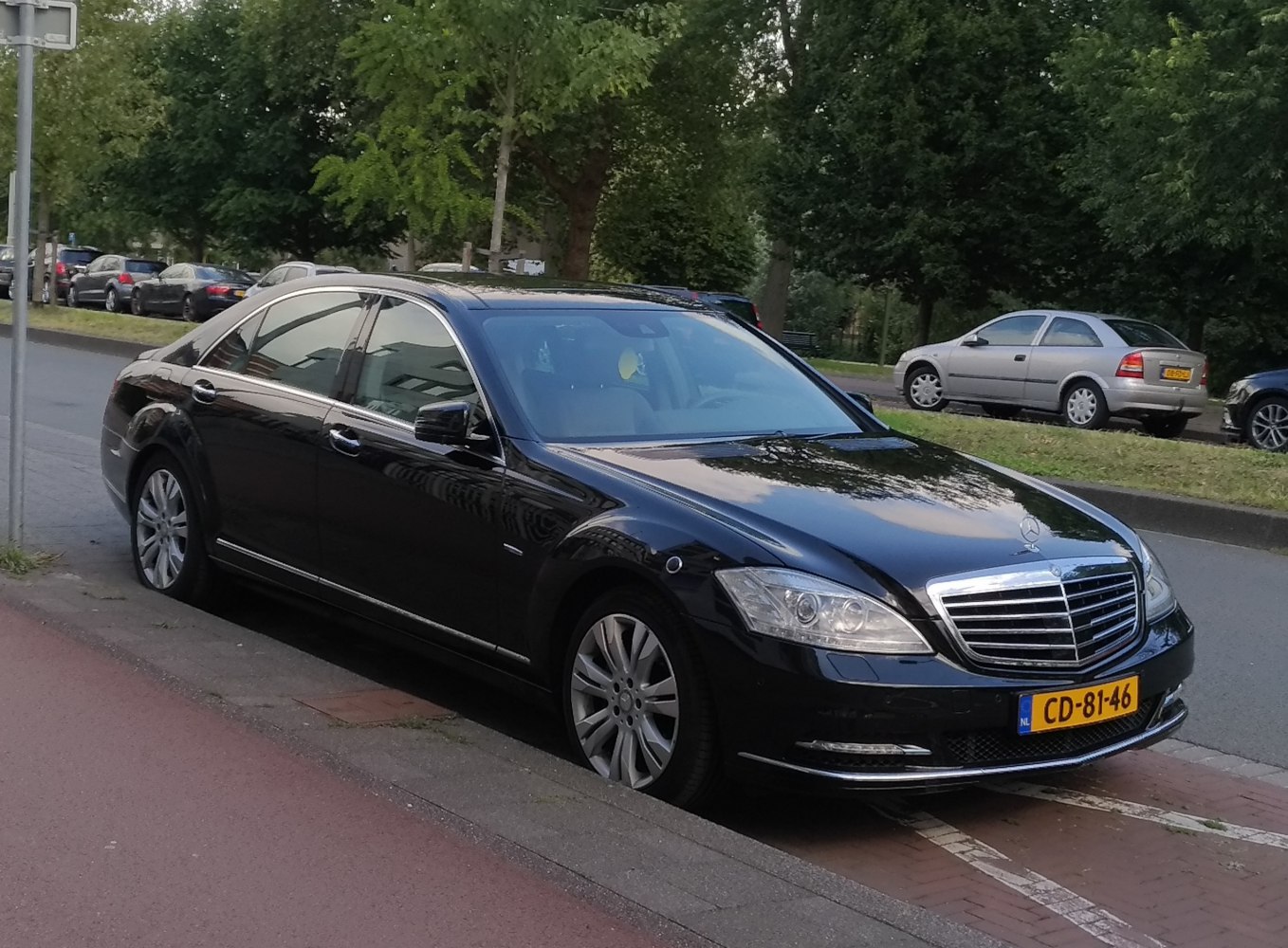Luxury sedan with bold chrome grille and multi-spoke alloy wheels