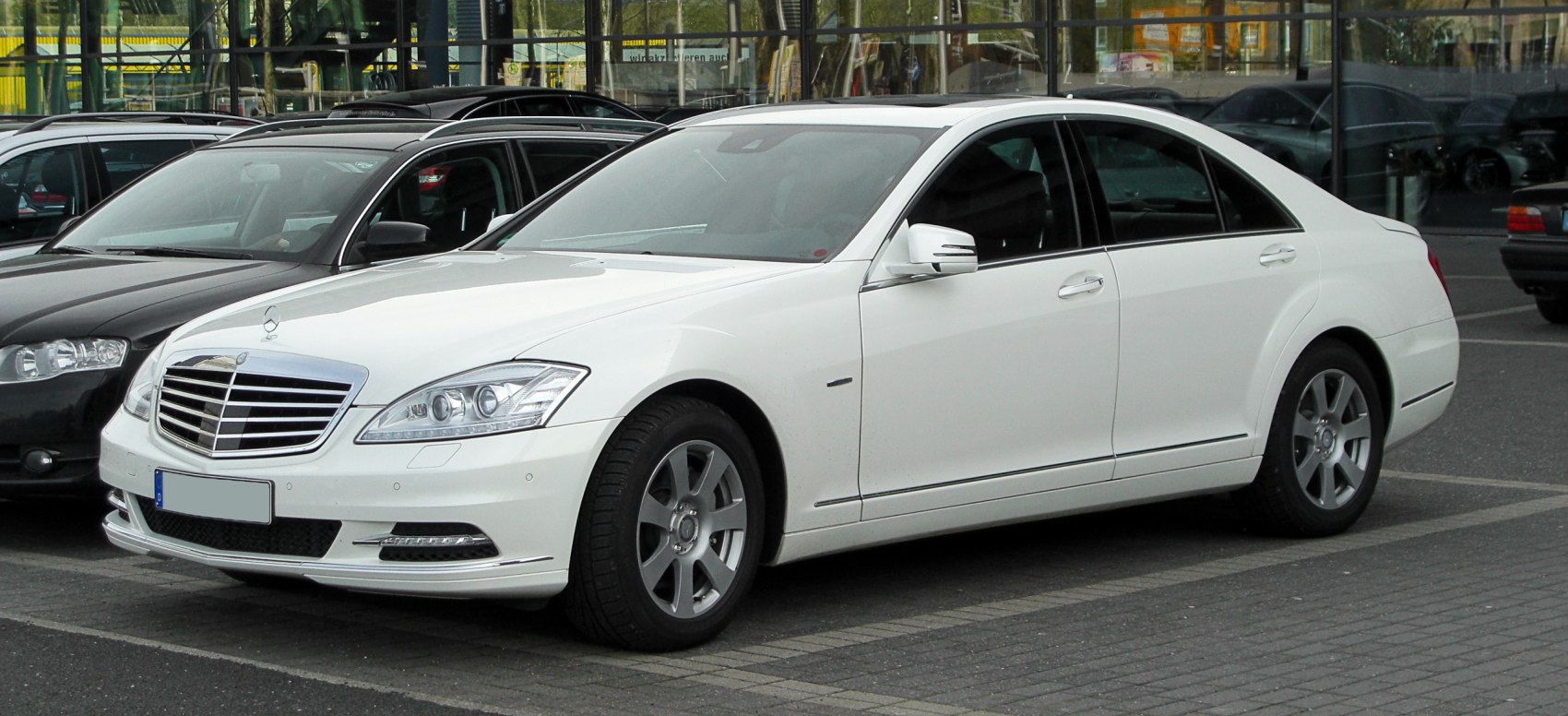 Luxury sedan front-side view with chrome grille and modern headlights