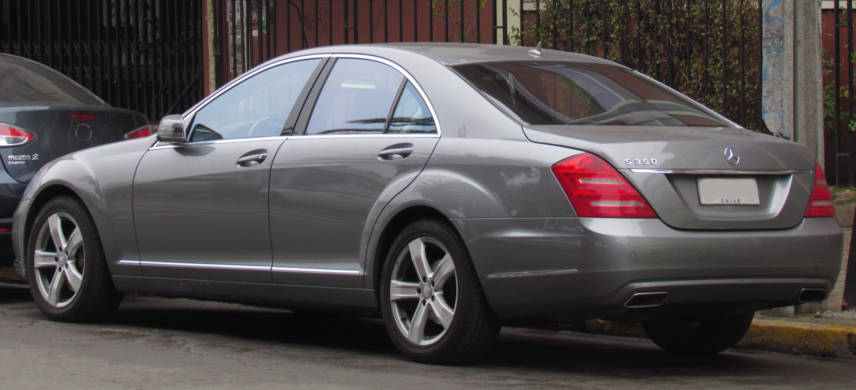 Rear and side view of luxury sedan with alloy wheels and distinctive tail lamps