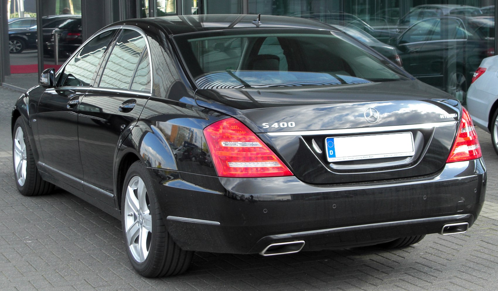 Rear view of luxury sedan with LED taillights and dual exhausts