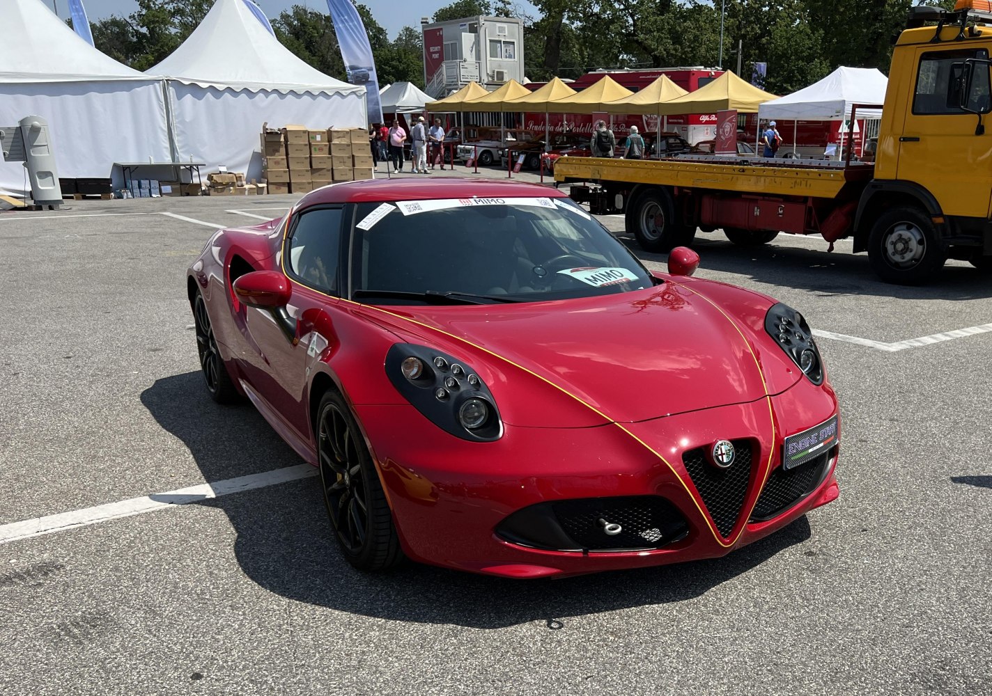 Red sports coupe with distinct multi-element headlights and aerodynamic shape
