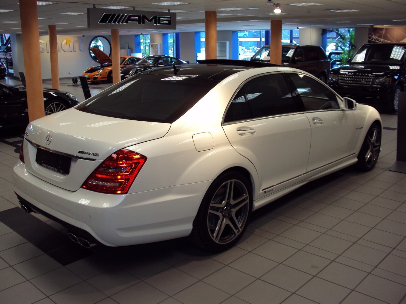 Luxury sedan rear with AMG package, quad exhausts, alloy wheels
