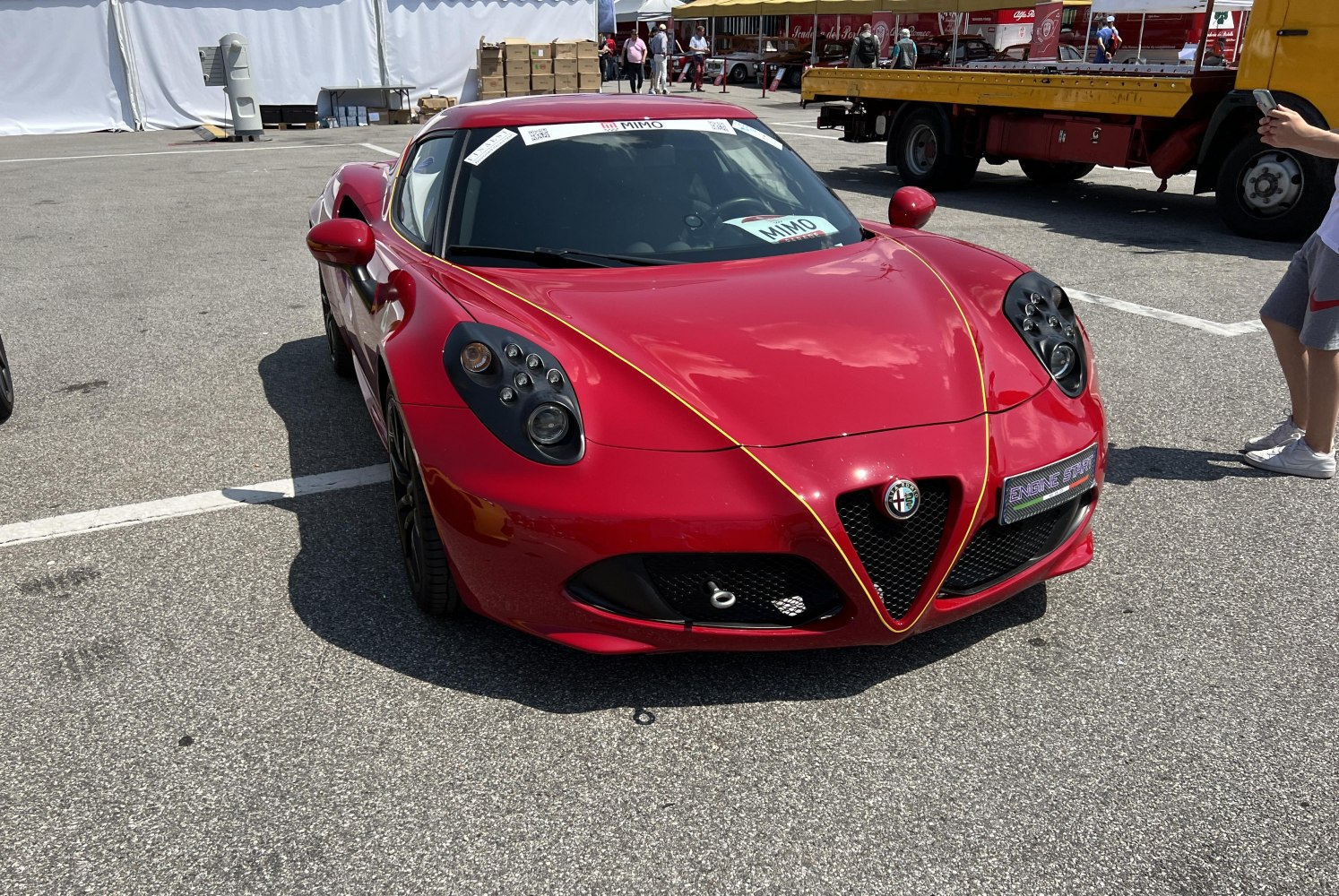 Distinctive quad headlights and V-shaped grille on red sports coupe