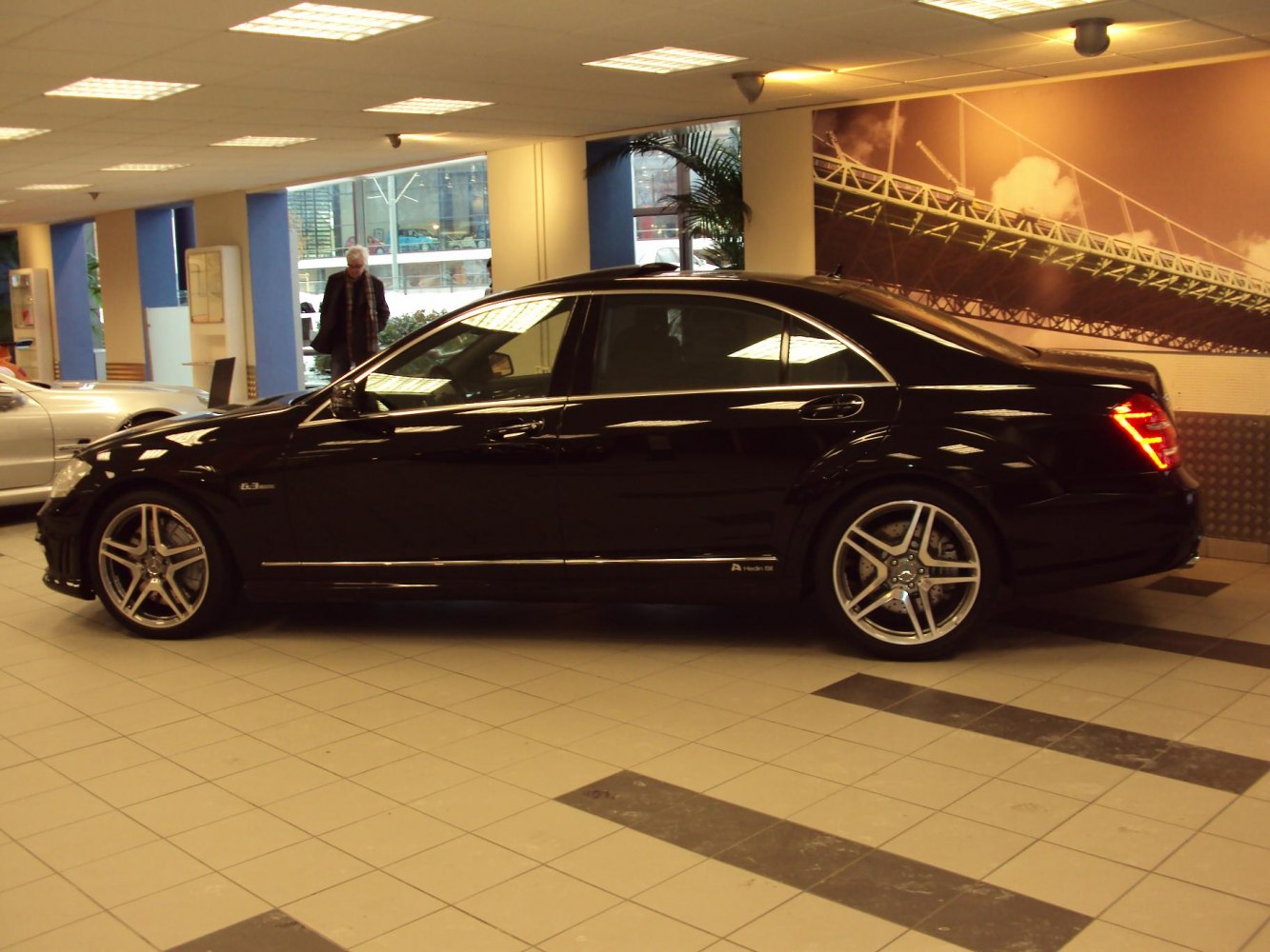 Side profile of black luxury sedan with AMG wheels