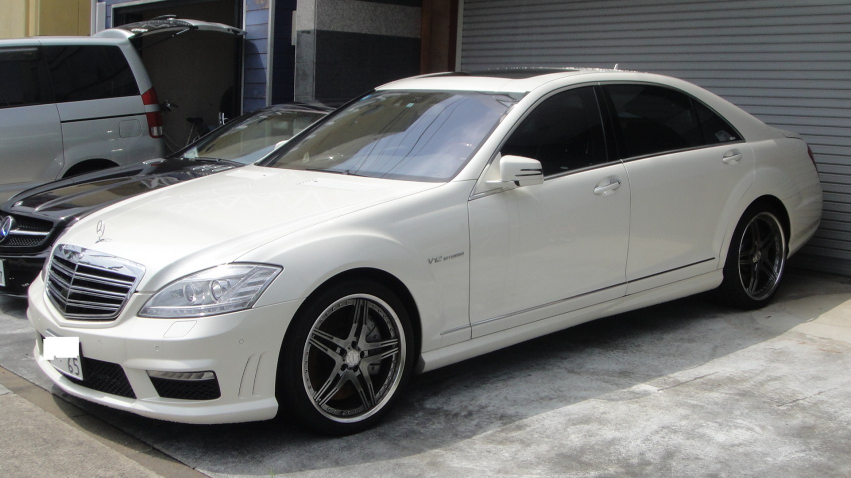 Front-side view of luxury sedan with AMG wheels